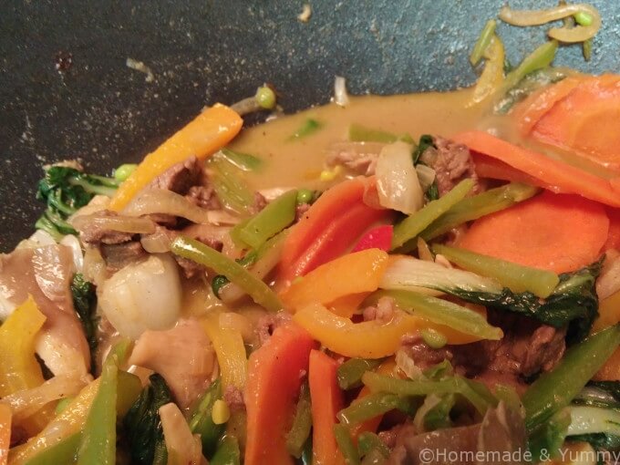 Put the veggies in the wok with the curry sauce and beef.