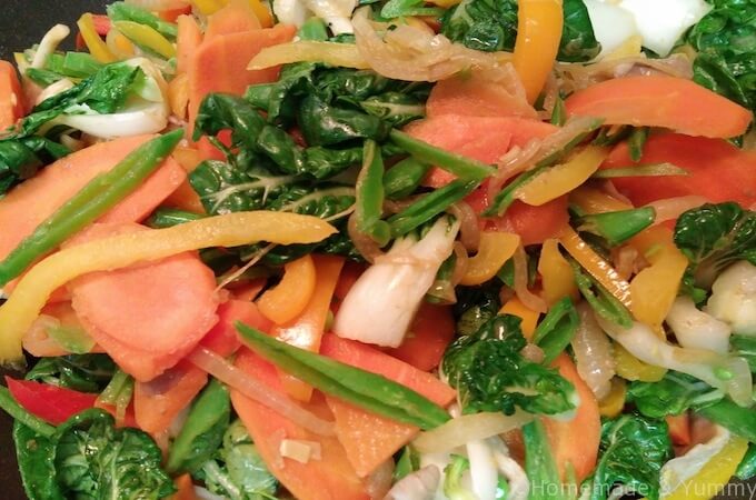 Stir fry the veggies for the  green Thai curry.