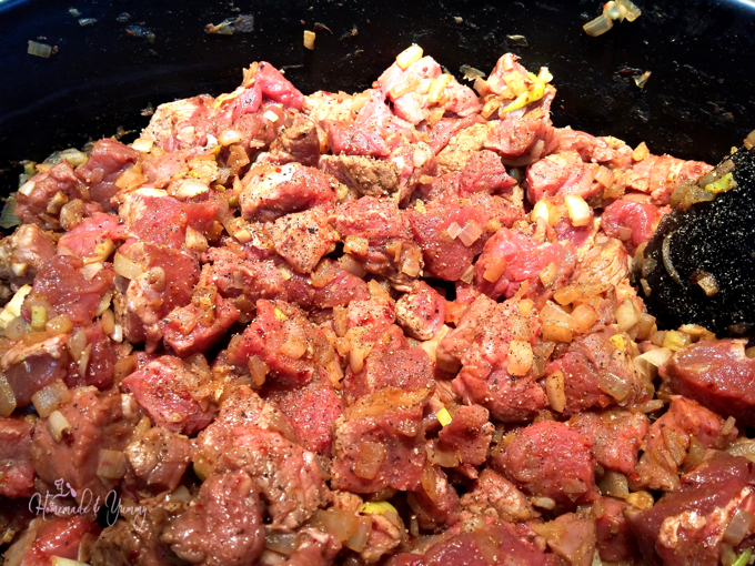 Closeup of the meat getting added to the chili pot.