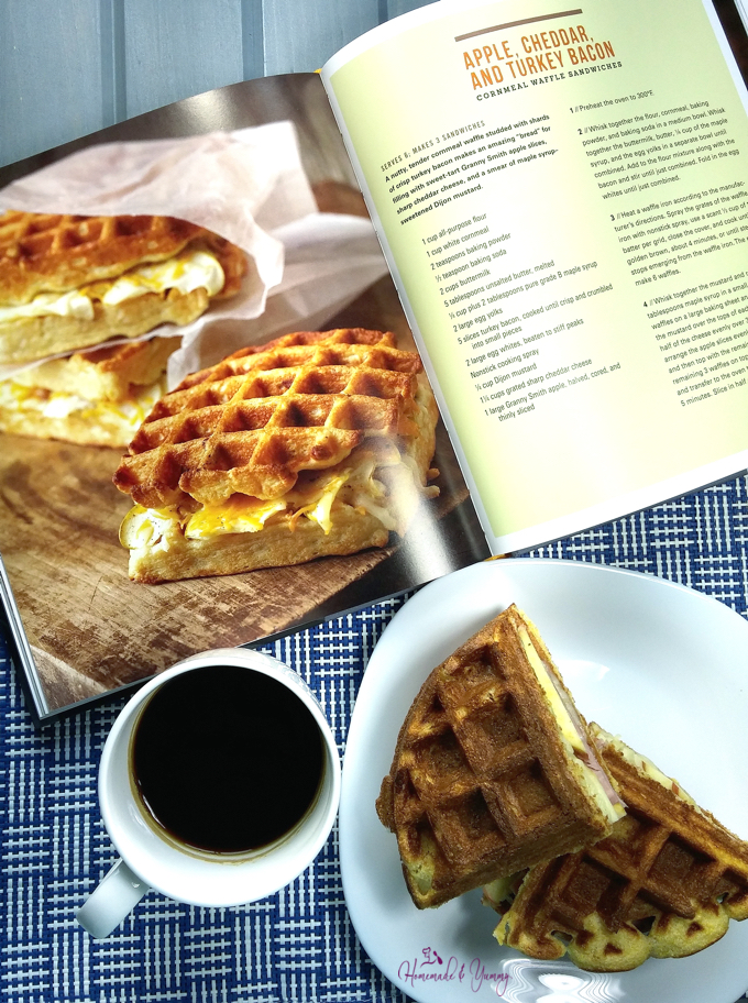 Image of cookbook opened to the recipe page, sandwich and a cup of coffee.
