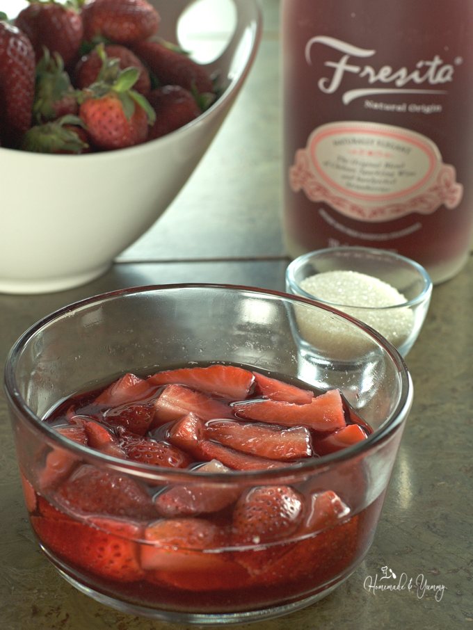 Strawberries soaking in covered in sparkling wine.