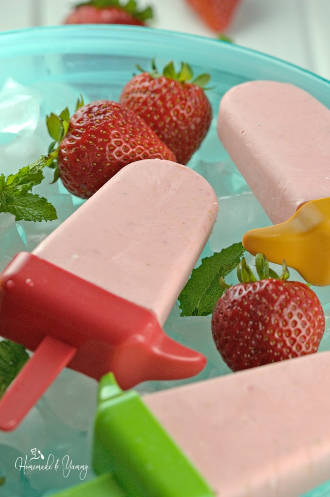 Homemade creamy strawberry ice pops.