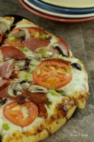Almost Homemade Pizza is easy to make and so much cheaper than takeout. Customize a store bought cheese pizza, bake and enjoy!! | homemadeandyummy.com