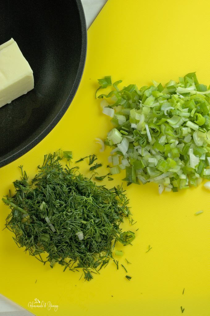 Chopped onion, dill and butter in a pan.