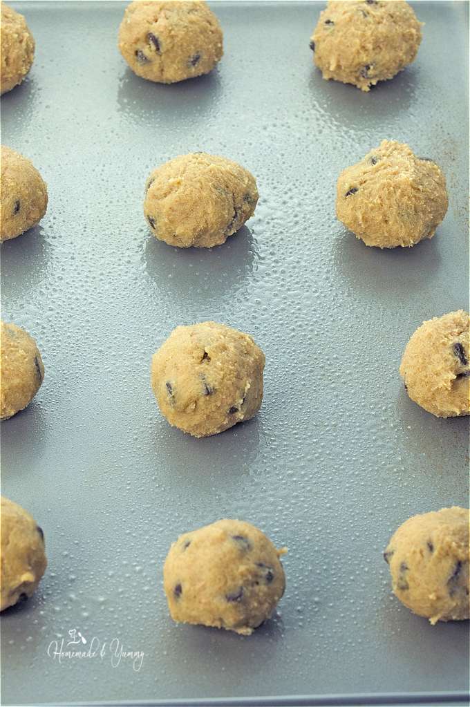Cookie dough balls on the tray before going into the oven.