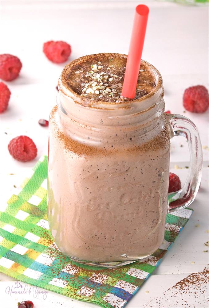 Chocolate smoothie is a glass mug with a straw.