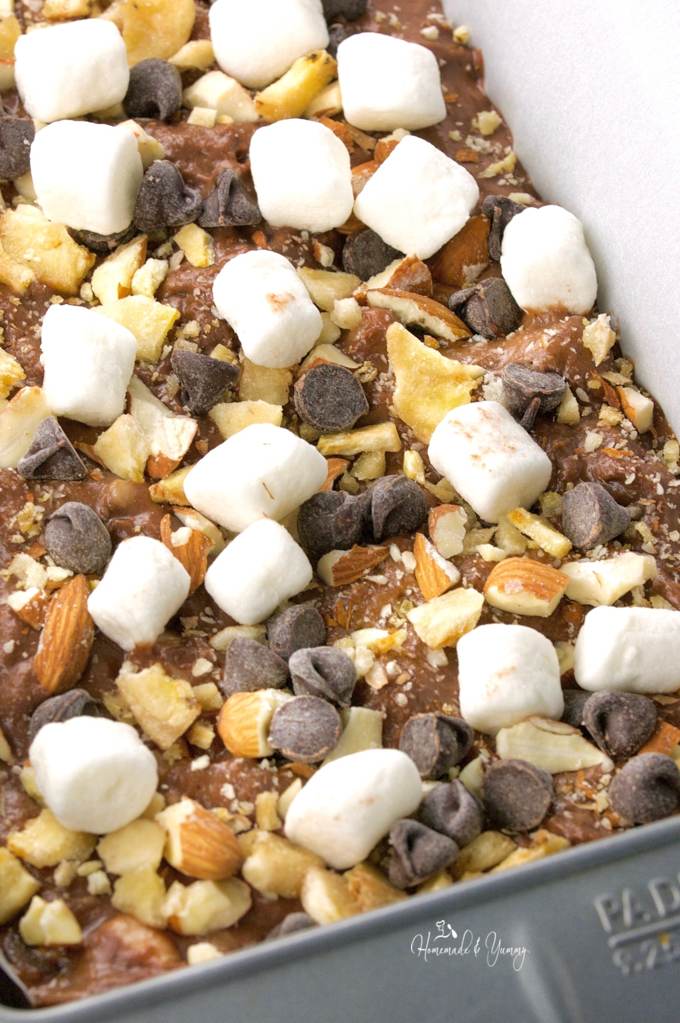 Close of the bread batter topped with mini marshmallows, nuts and chocolate chips prior to going into the oven.