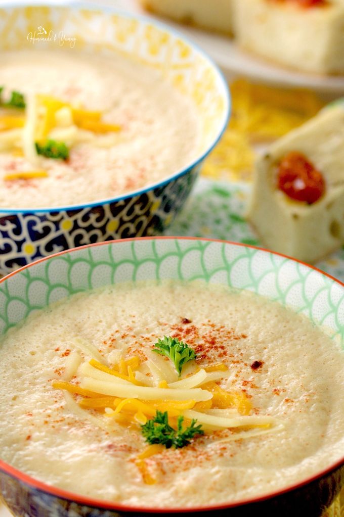 Cheese garnish on a bowl of creamy soup made with cauliflower.
