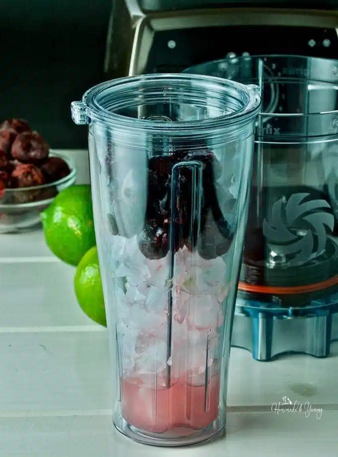 Adapter cup with ice, cherries and lime juice ready to blend.