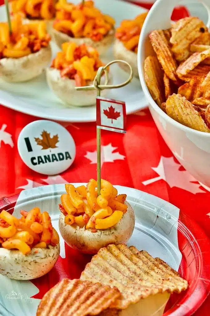Mushroom bites on a plate with more in the background and I Love Canada flags.