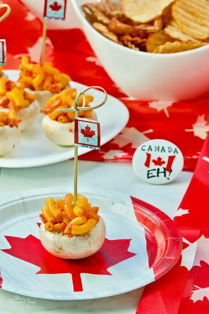 Mushrooms stuffed with macaroni with Canadian flag topper decoration.