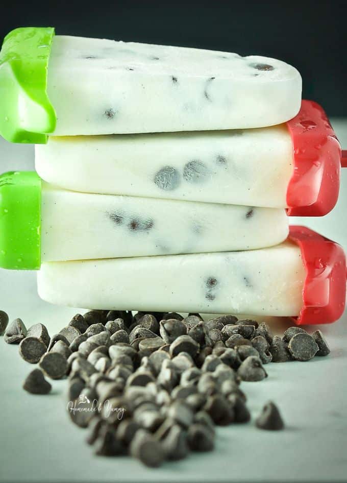 Kefir popsicles plied on top of each other with chocolate chips in the foreground.