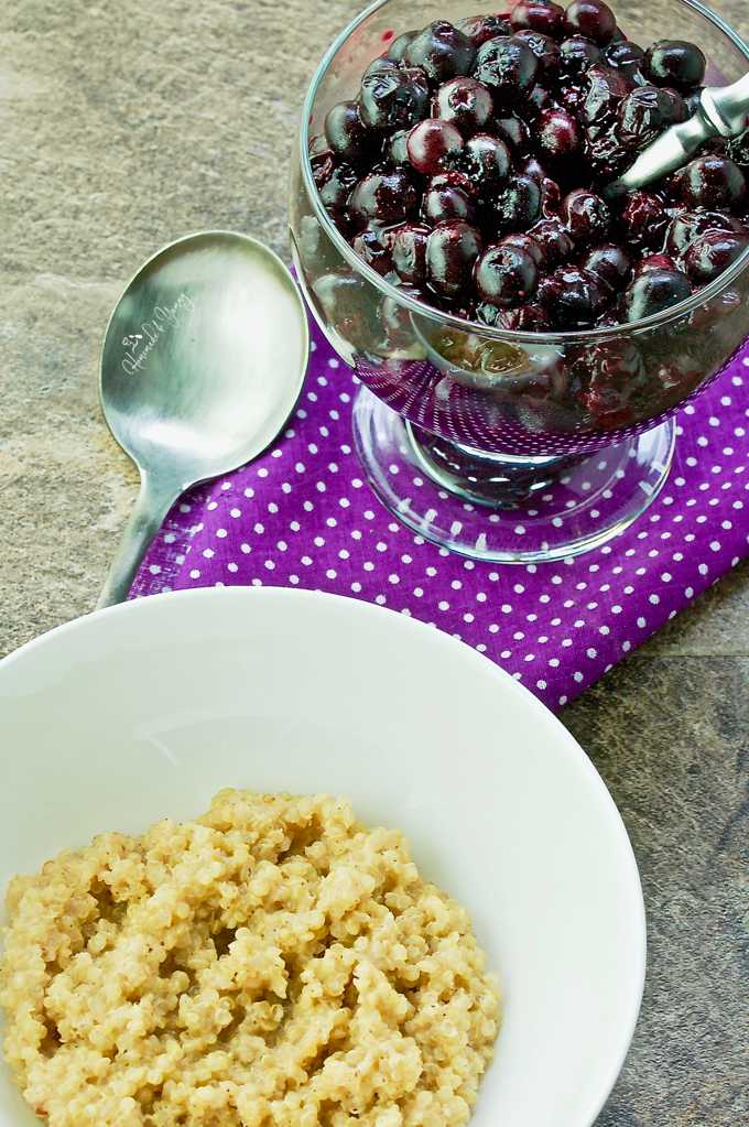 Quinoa in a bowl with roasted blueberries on the side.