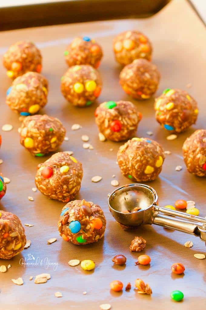 No Bake Peanut Butter Oatmeal Cookie Balls lined up on parchment paper.