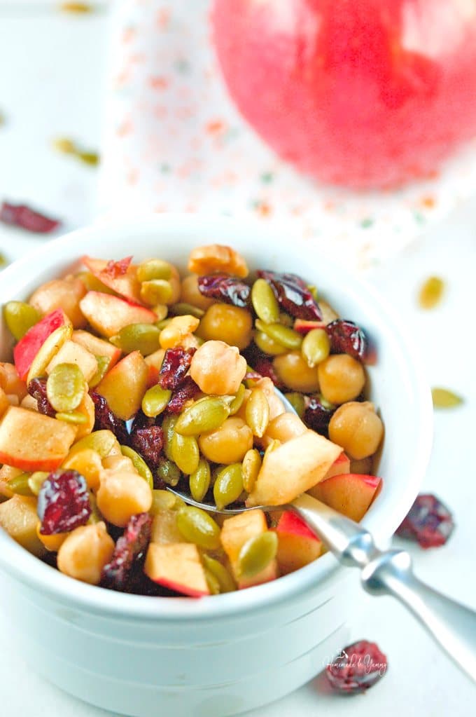 Gluten-free salad with chickpeas, apples, pumpkin seeds and cranberries.
