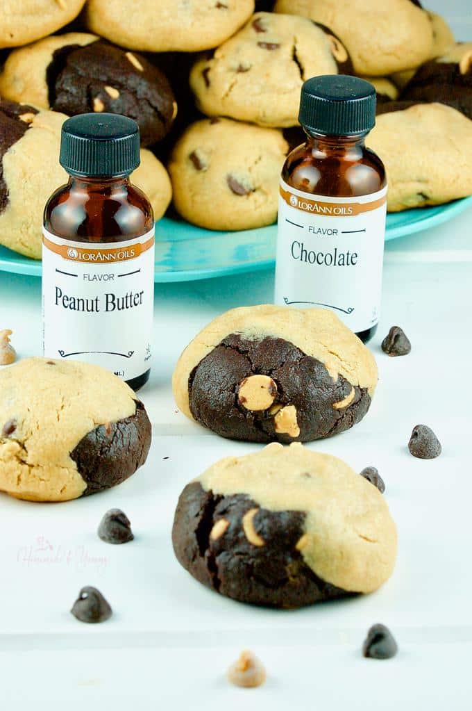 Peanut Butter Reverse Chocolate Cookies on a plate with bottles of the flavoured extract used in the recipe.