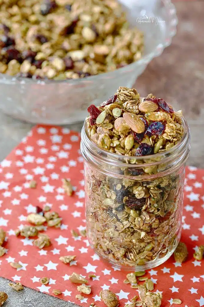 Holiday granola in a jar on a red star placemat.