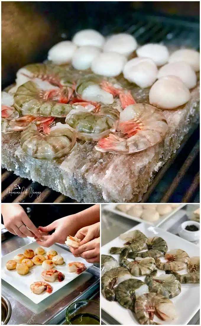 Grilling seafood namely shrimp and scallops on a salt stone