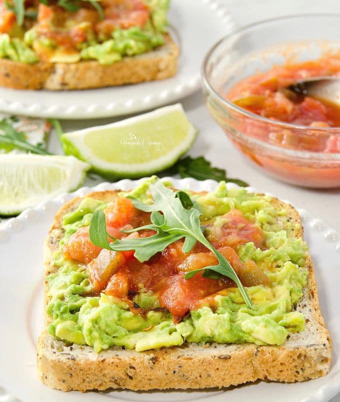 Smashed Avocado Toast Topped with Salsa ready to eat.
