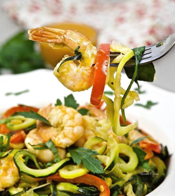 Close up shot of Zucchini Noodles and Shrimp on a fork.
