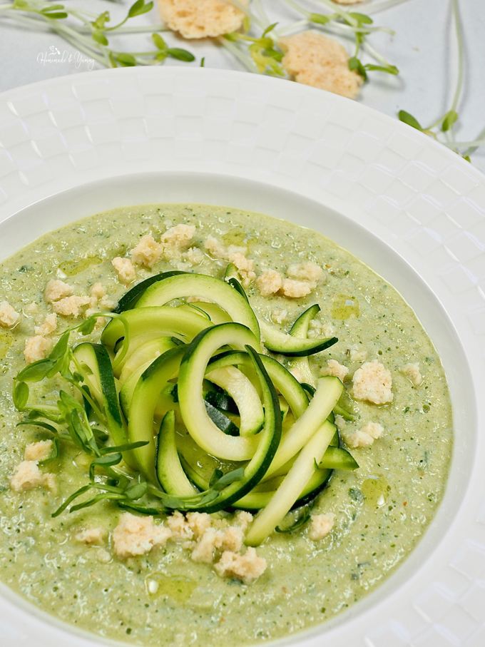  zucchini gazpacho garnished with zucchini noodles, parmesan crips, pea shoots and olive oil.