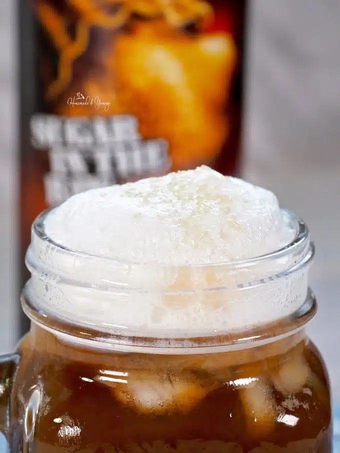 Close up of cold foam on top of the glass of french press cold brew