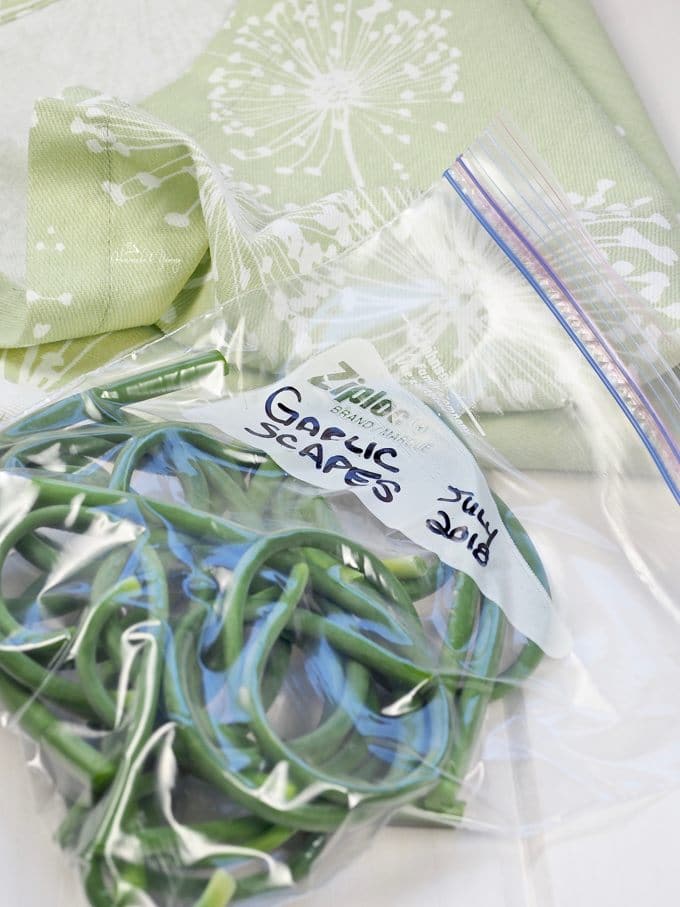 Raw garlic scapes in a bag ready for the freezer.