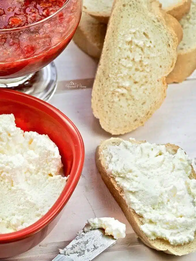 Bread slices topped with ricotta cheese.