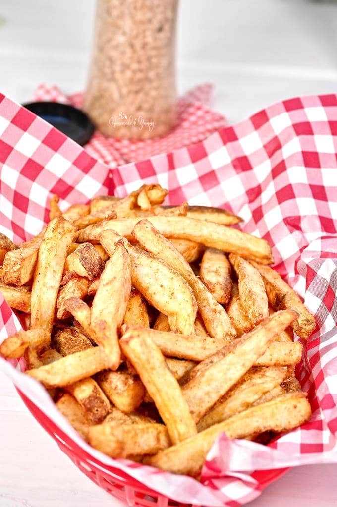 A basket full of spicy fries ready to eat.