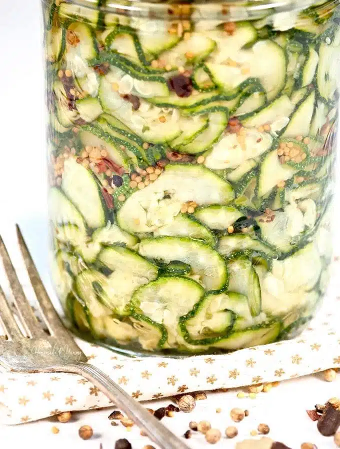 A jar of zucchini pickles read to go into the fridge.