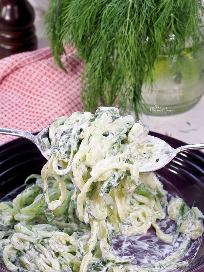 Cucumber noodles getting mixed with the sour cream dressing.