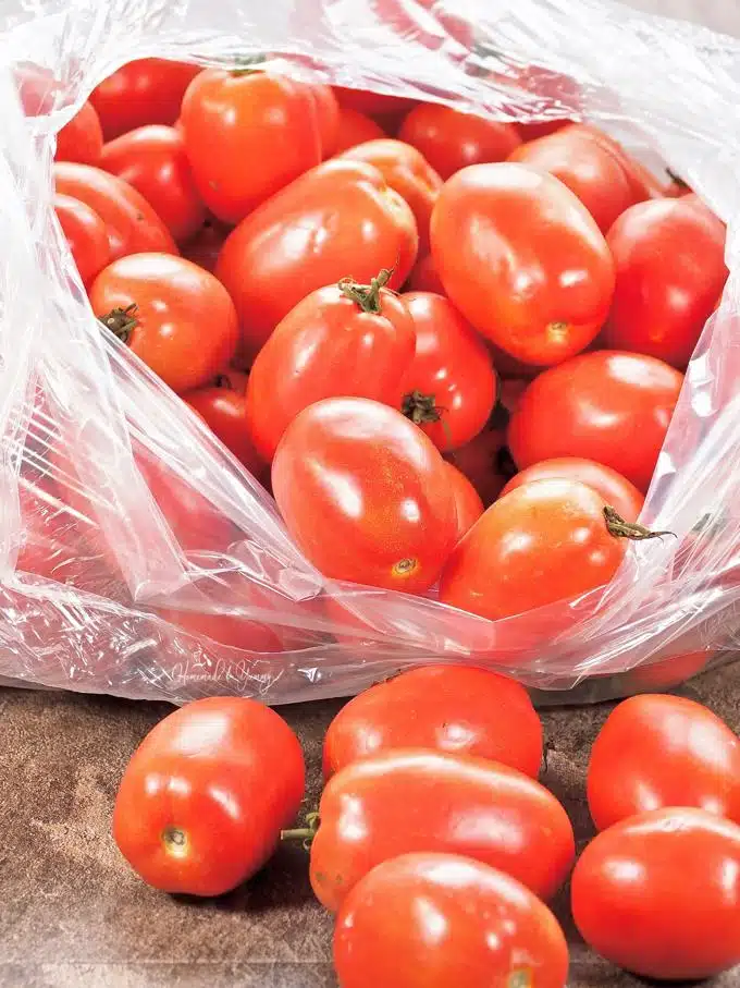 A bag of fresh Roma tomatoes.