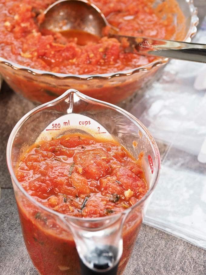 Cooked tomatoes in a measuring cup.
