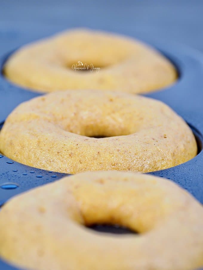 Baked Pumpkin Spice Donuts right out of the oven still in the donut pan.