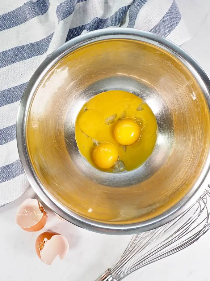 Egg yolks in a bowl ready to whip.