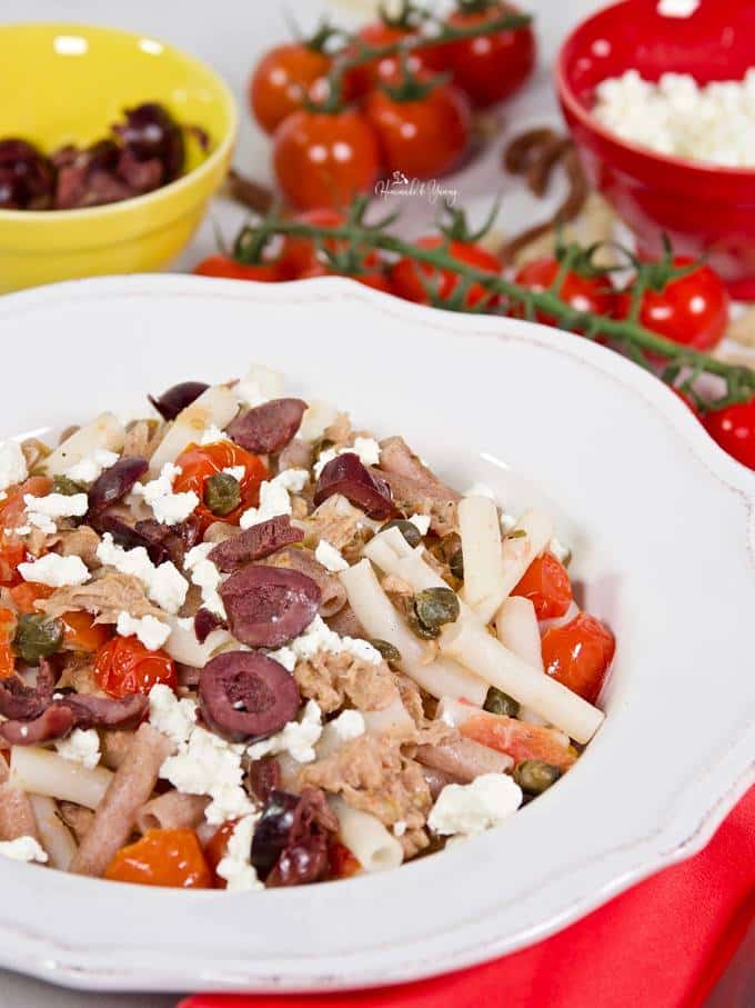 Mediterranean Canned Tuna Pasta Toss garnished with black olives and feta cheese.