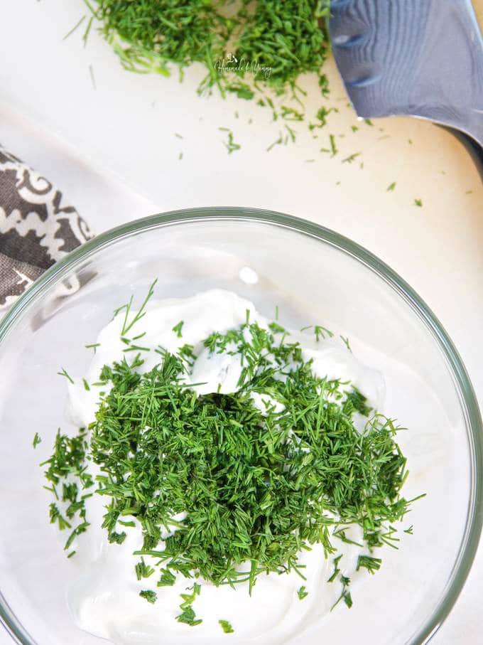 Sour cream and dill getting combined for the dip.