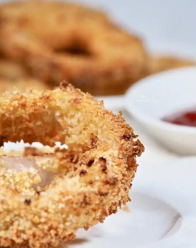 Close up of the crispy coated onion ring ready to eat.