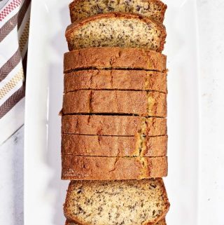 Overhead shot of Simple Basic Banana Bread sliced on a serving plate.