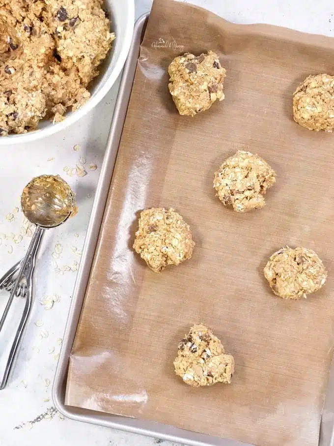 Oatmeal chocolate chip cookies getting scooped into balls.