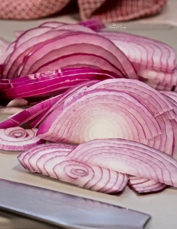 A pile of thinly sliced red onions.