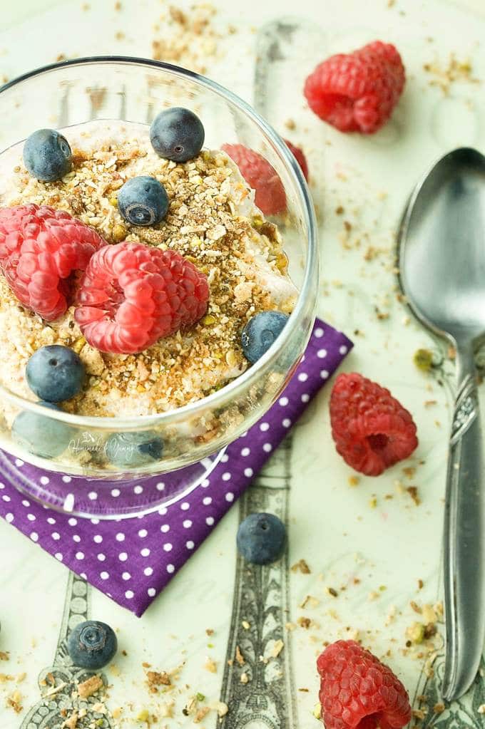 A bowl of yogurt topped with berries and granola.