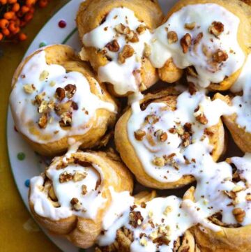 Pumpkin spice cinnamon buns with frosting.