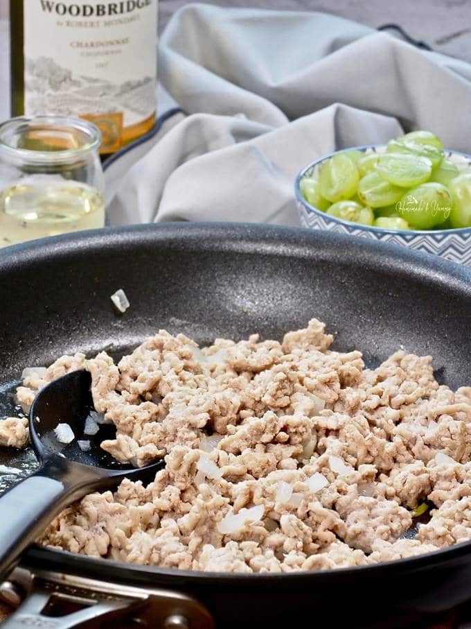 Ground turkey cooking in a pan