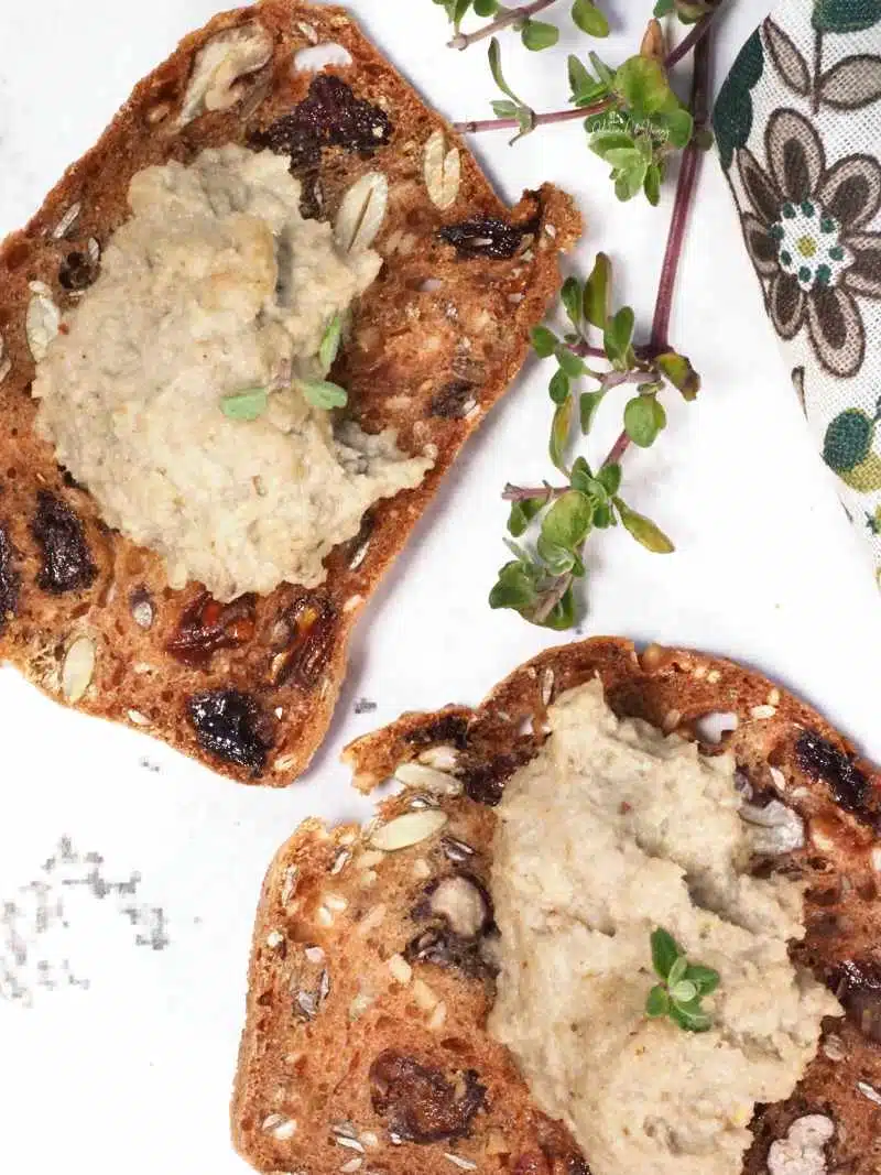 2 crackers topped with vegan mushroom spread.