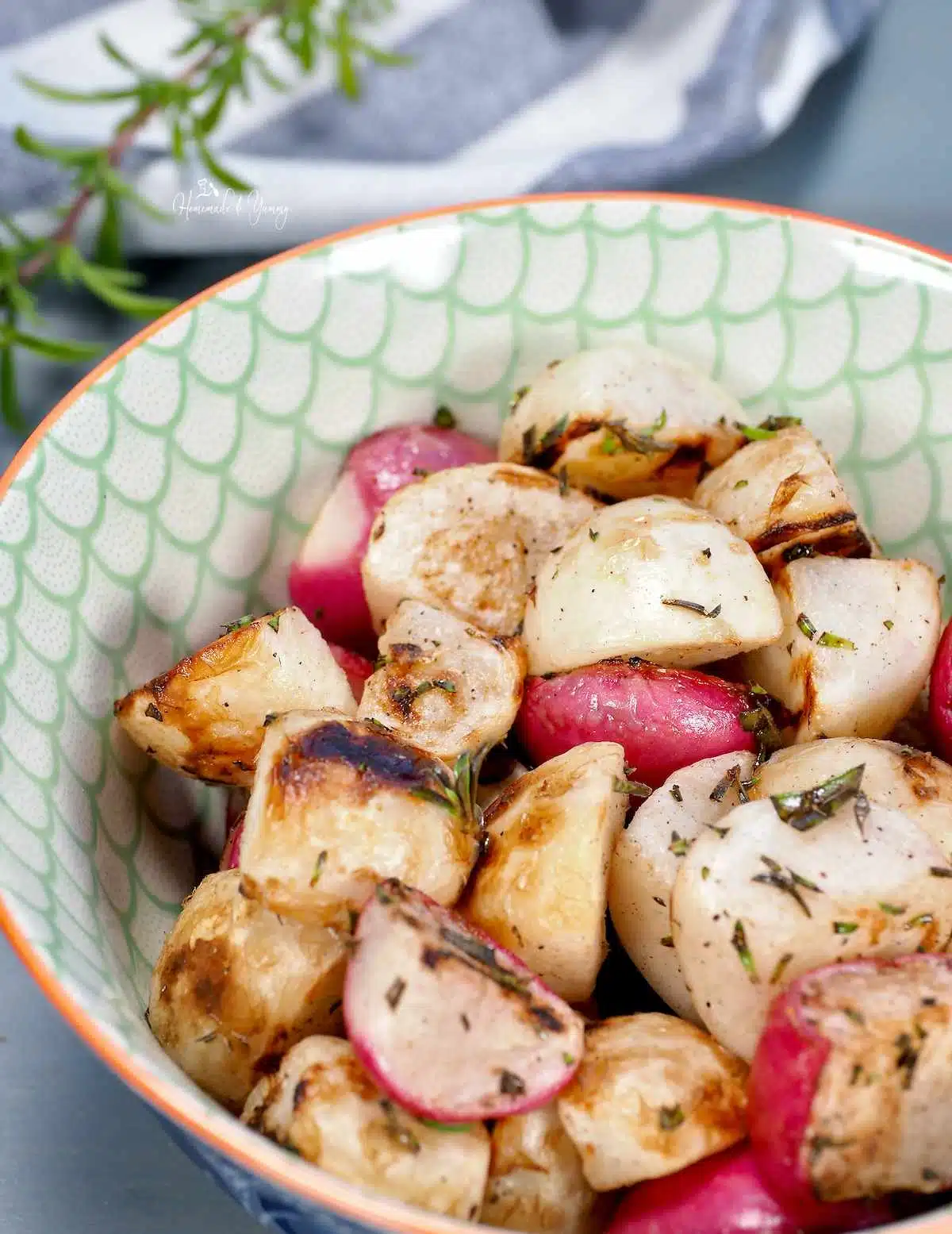Close up shot of a bowl with grilled Japanese turnips and radishes ready to serve.