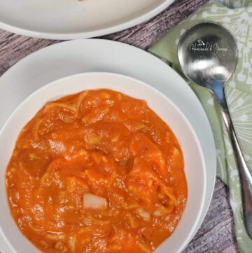 Roasted Tomato Soup with Crab in a white bowl.