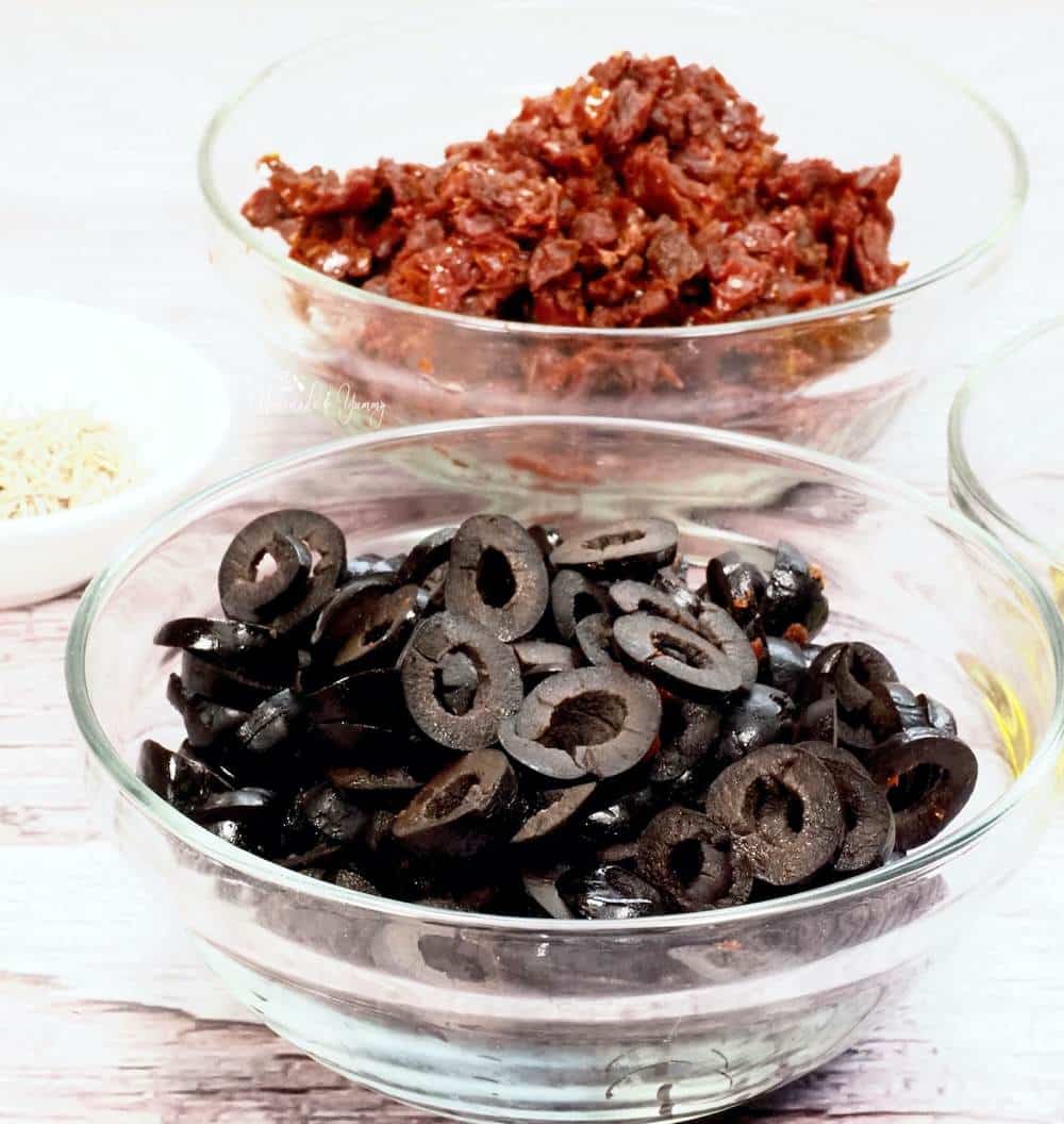 Sun-dried tomatoes and black olives in bowls