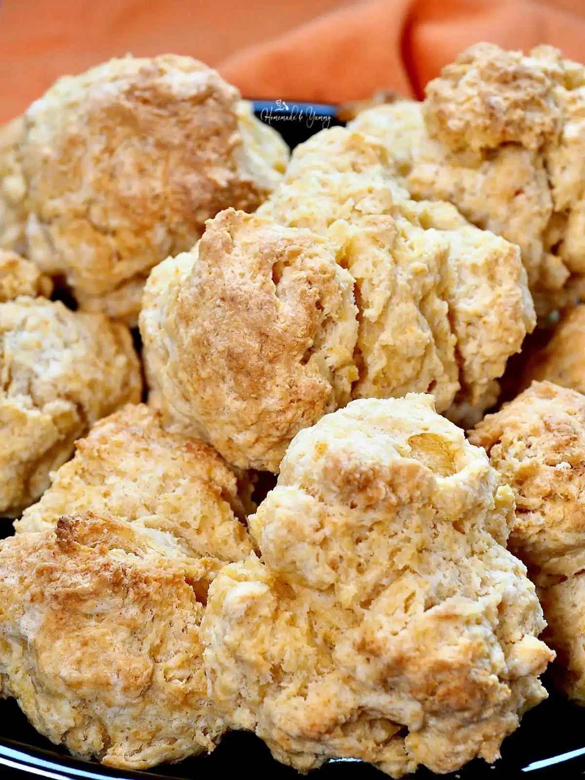 A pile of gramma's biscuits on a plate.