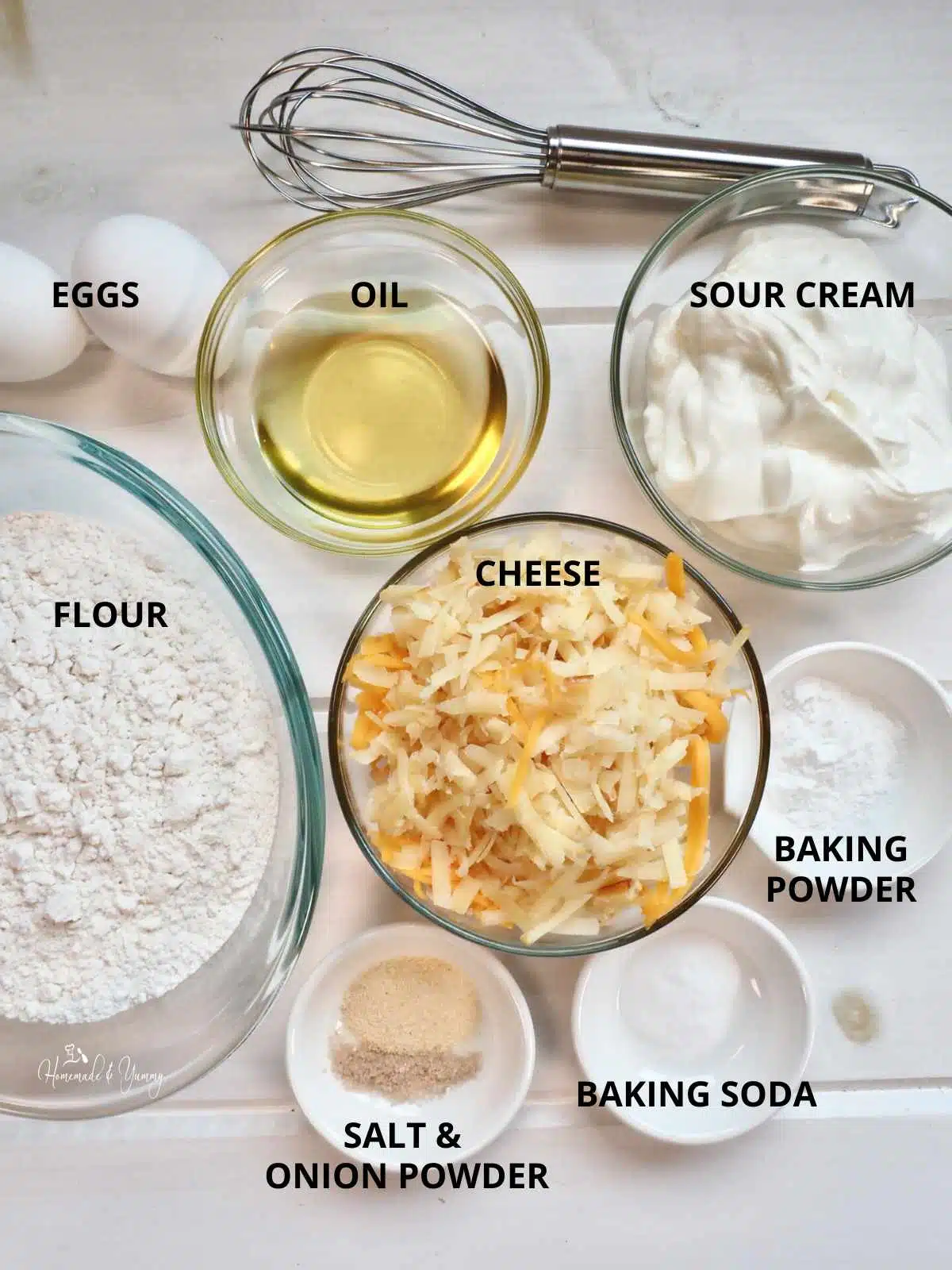 All the ingredients to make homemade cheese muffins.
